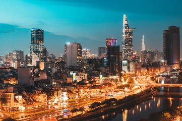 Fototapeta na wymiar Aerial view of the city skyline of Ho Chi Minh City, Vietnam in late evening with street lights and river