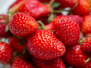 Harvest of red tasty strawberries closeup