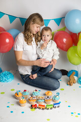 Fototapeta na wymiar the son feeds his mother a holiday cupcake . birthday of the child