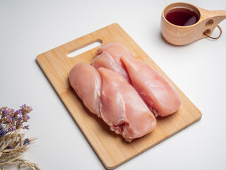 Fresh chicken fillet on a wooden board