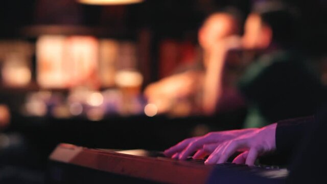 The hands of a musician closeup of the melody on the synthesizer.