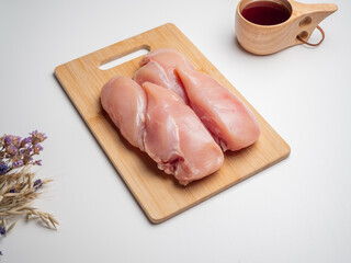Fresh chicken fillet on a wooden board