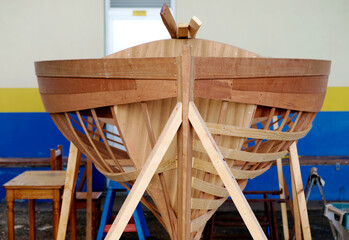 A small wooden boat design being built.