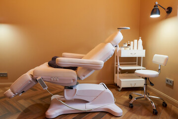Modern interior of the cosmetology office with facial beauty bed in a salon.