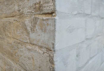 Brick corner of a white wall, house with a split in half. Photography, concept, texture, copy space.