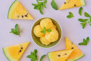 Yellow watermelon sorbet with mint leaves