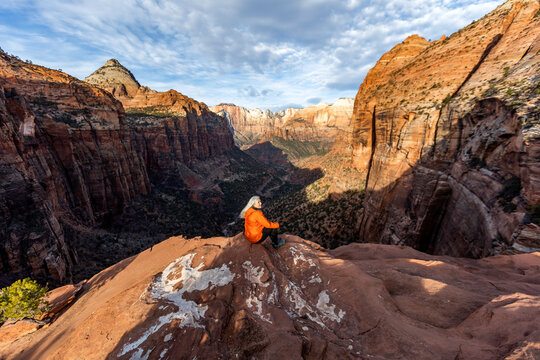 Woman sitting on cliff at Zion National Park in Utah, USA