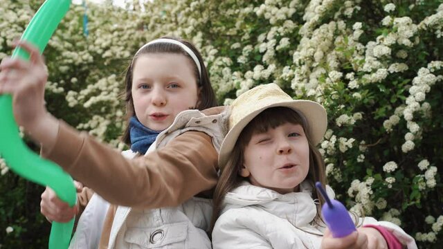 Two funny gangster girls shoot from balloons