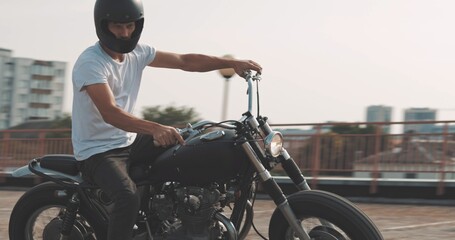 Biker riding on motorcycle in parking lot