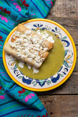 Mexican drowned flautas with green sauce also called 