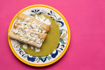 Mexican drowned flautas with green sauce also called 
