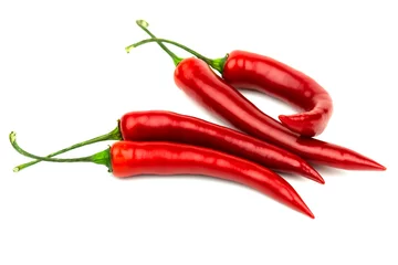 Fotobehang Several red hot peppers on a white background © Pavel
