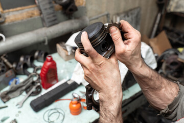 Fototapeta na wymiar Car worker repair a pistons in autoservice. Piston defective checking.