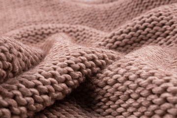 Large folds on a warm wool blanket knitted from threads