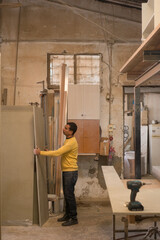 man working in carpenter workshop 