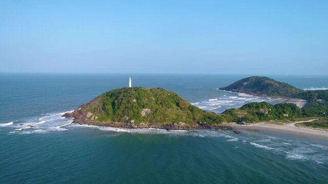 Beatiful lighthouse on the top of a montain of an island with beaches and blue sky 