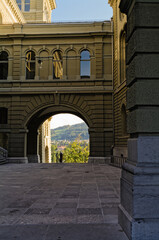 Archway in downtown area of Bern, Switzerland, overlooking the river Aare and mountain Gurten.
