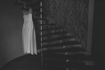 wedding dress hanging on the stairs in black and white