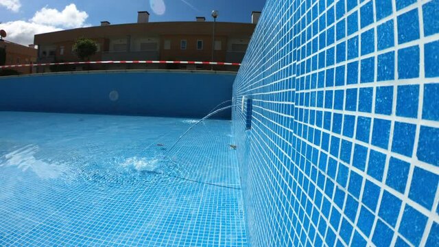 SLOW MOTION SHOT - pool with blue tiles. Return inlets in a swimming pool.