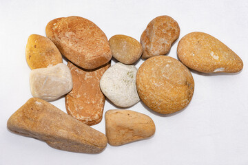 Scattered sea pebbles. Smooth stones isolated on white background
