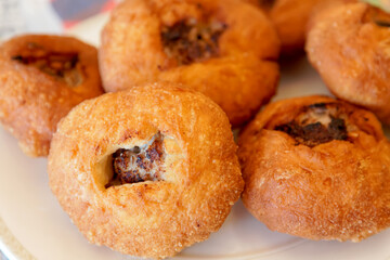Close-up of Tatar deep-fried patties belyashi with meat and onions. 