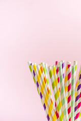  Multi-colored striped paper tubes for drinks, cocktails. The concept of party, celebration, birthday. Copy space.