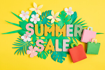 Word Sale over tropical paper cut leaves background. Summer sale, online deals, discounts idea