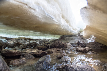 The thawing and post winter ice that has partially melted under the Wheaton River in Yukon Territory, Canada. 