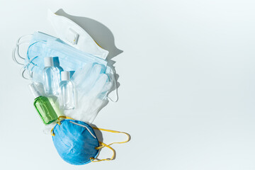 Set of protecting disposable filtering face masks, gloves, sanitizers for hands on white...