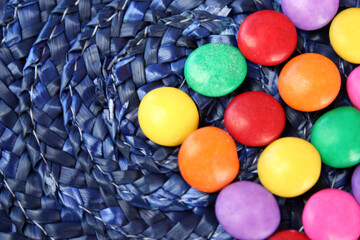 colorful chocolate candies on a blue textured background