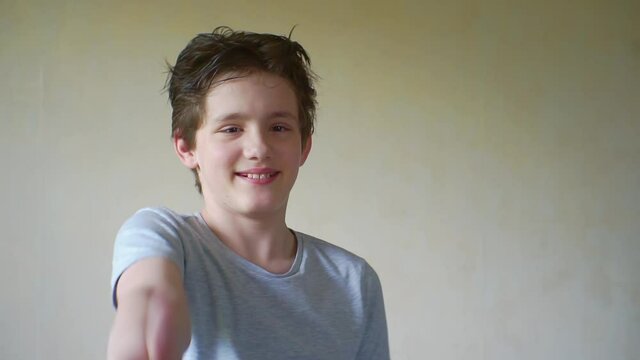teenager showing a thumb up gesture to the camera