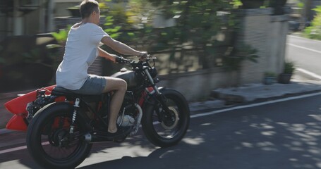 Fototapeta na wymiar Motorcyclist driving his motorbike