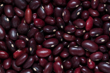 of bright burgundy raw bean beans create a beautiful dark background