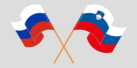 Crossed and waving flags of Slovenia and Russia