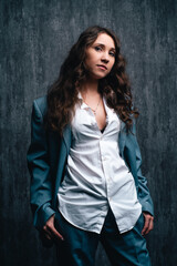 Beautiful girl in a suit and a man's shirt in the Studio