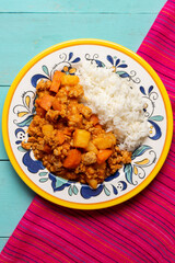 Mexican picadillo with rice on turquoise background