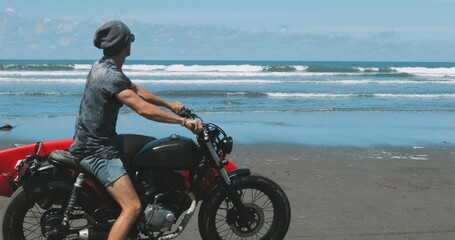 Motorcyclist driving his motorbike on the beach