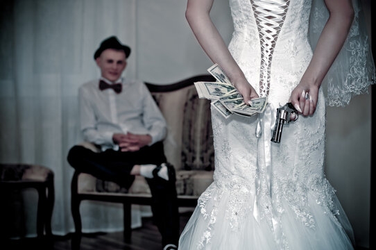 bride with a gun behind her back