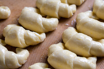 Ready to bake, raw Argentine croissants, medialunas de Manteca over silicon pastry mat