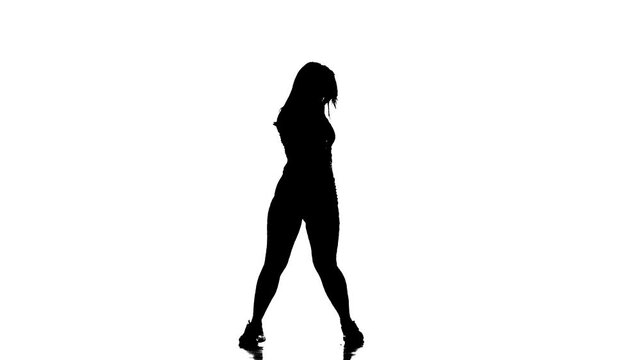 black silhouette on a white background, young beautiful girl dancer in fishnet tights and shorts dancing dancehall twerk, street modern dance, long shot