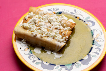 Mexican drowned flautas with green sauce also called 