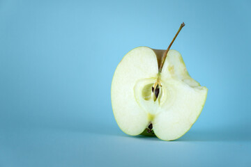 bitten half apple and blue backgrounds