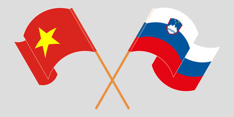 Crossed and waving flags of Slovenia and Vietnam