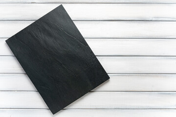 Dark grey and black stone slate background or texture on white wood background table. Flat lay top view copy space.
