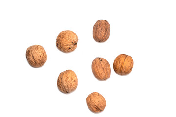 Greek nuts are scattered on a white isolated background. Autumn fruits of trees. Random location