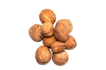 Greek nuts are scattered on a white isolated background. Autumn fruits of trees. Random location