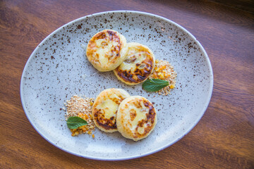cheesecakes with honey served on a plate close up