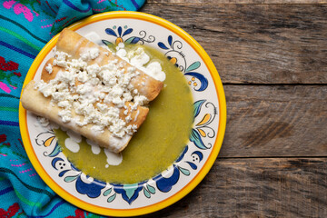 Mexican drowned flautas with green sauce also called 