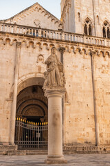 Statue of St Lawrence with St Lawrence cathedral in Trogir, Croatia.