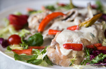 rabbit stewed in a creamy sauce served with vegetables and strawberries	